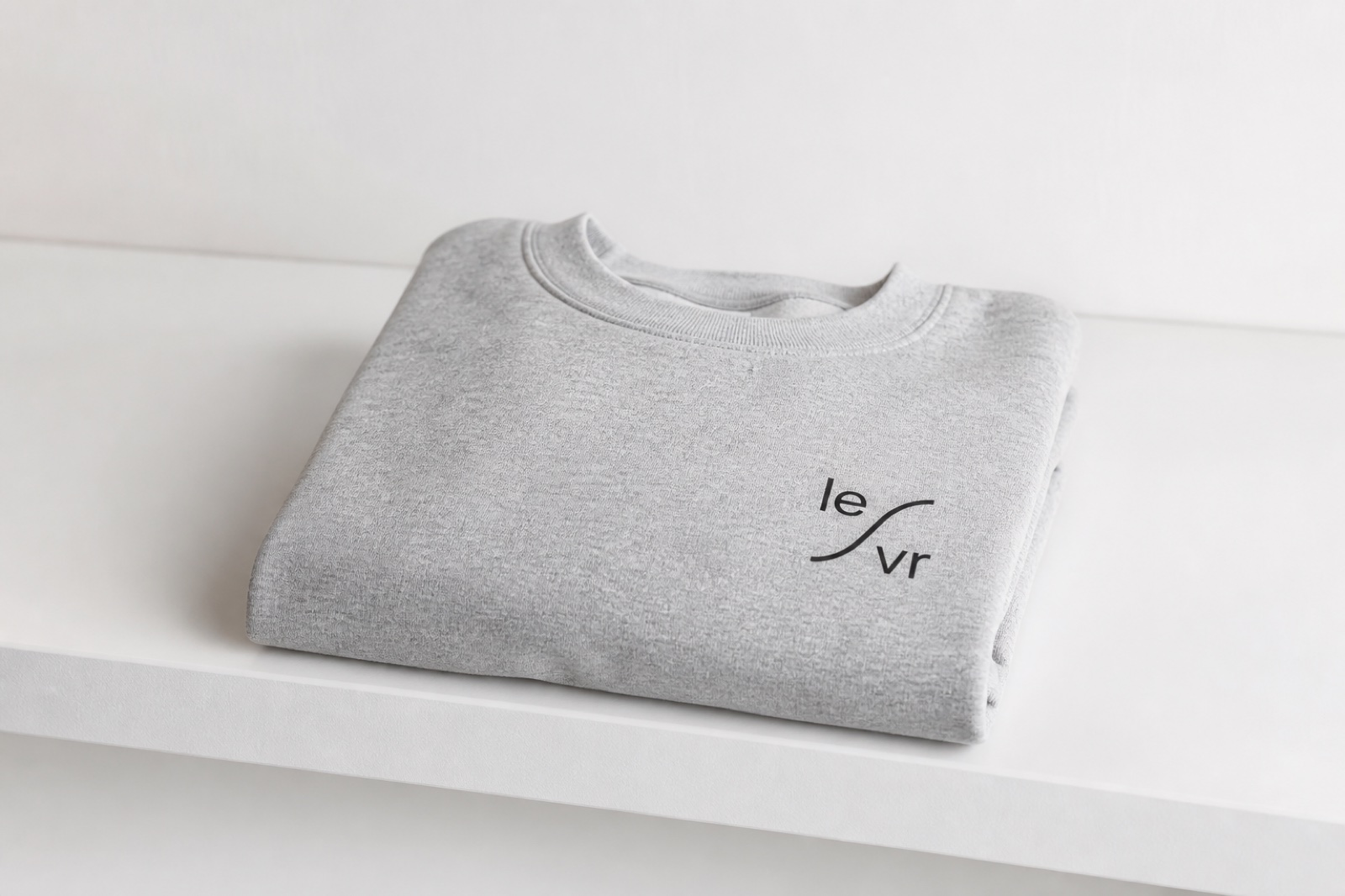LEVR single-color mark on a grey crewneck.