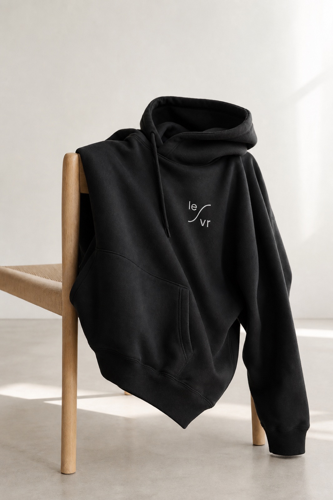 LEVR mark embroidered on a black hoodie.